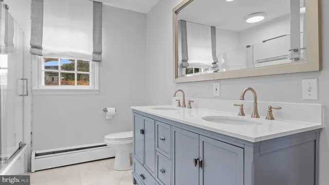 a bathroom with a glass shower door