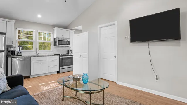 a kitchen with stainless steel appliances granite countertop a sink and a microwave