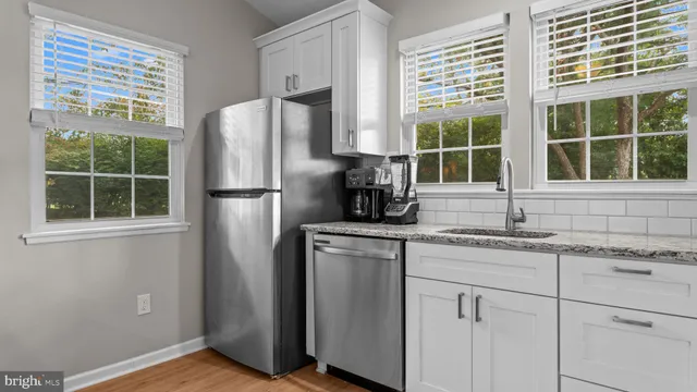 a bedroom with a bed a chair and a window