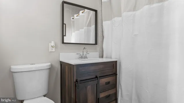 a view of storage and utility room with closet