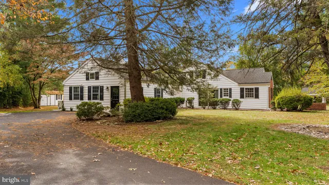 a front view of a house with yard and green space