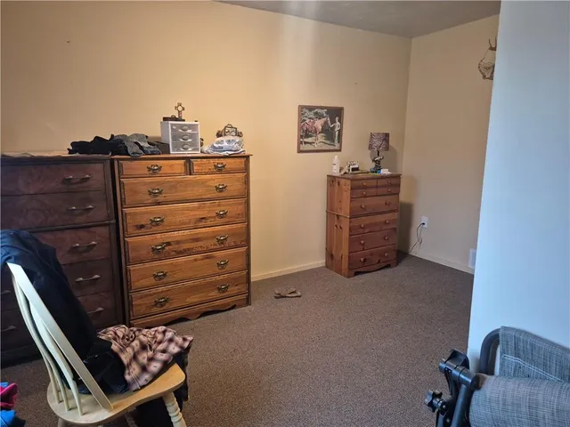 a view of a bedroom with furniture window and a ceiling fan