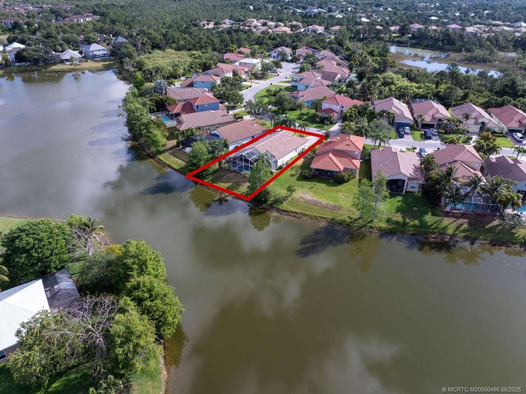 2096 Northwest Marsh Rabbit Lane Stuart, FL 34994 - Photo 12 of 58 an aerial view of residential houses with outdoor space and lake view