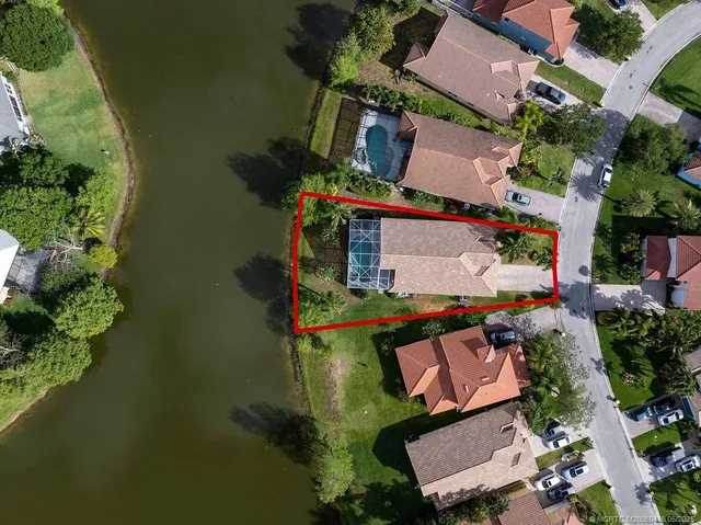 an aerial view of a house with a yard