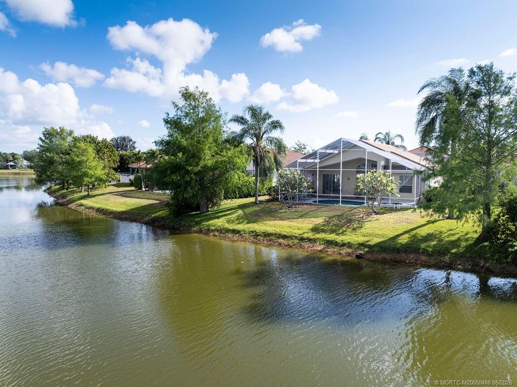 2096 Northwest Marsh Rabbit Lane Stuart, FL 34994 - Photo 19 of 58 a view of a swimming pool with a lake view