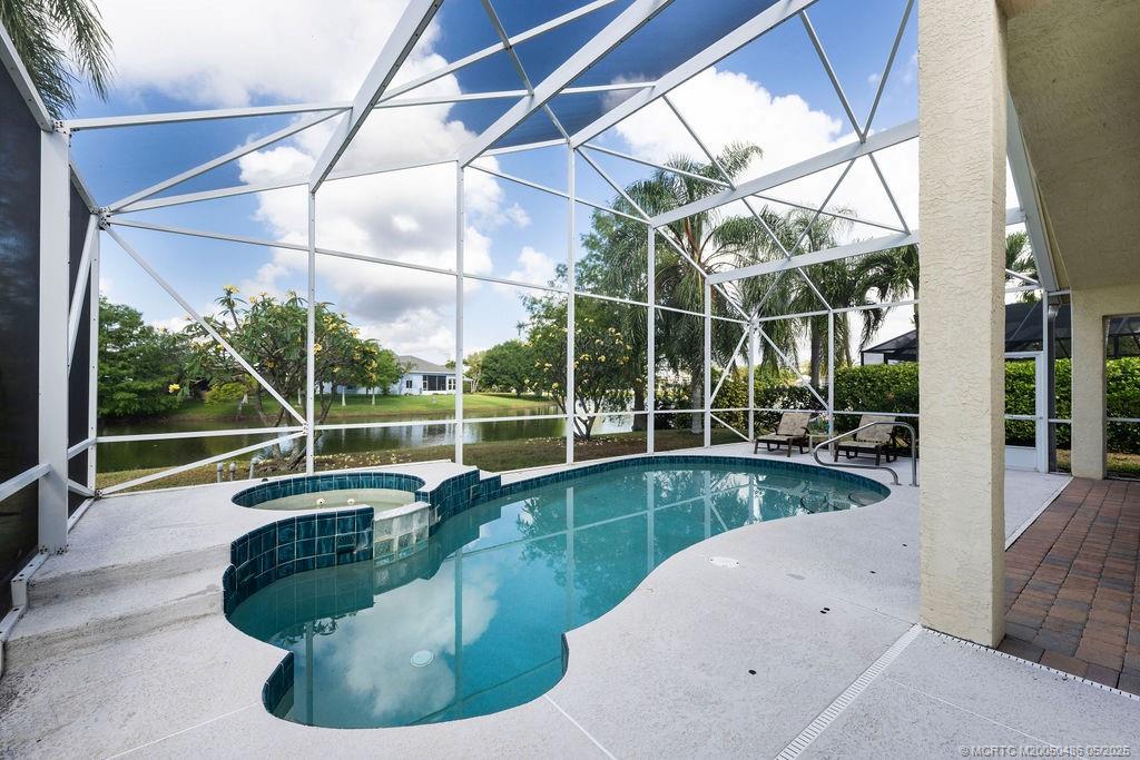 2096 Northwest Marsh Rabbit Lane Stuart, FL 34994 - Photo 26 of 58 a view of a swimming pool with a couches and table