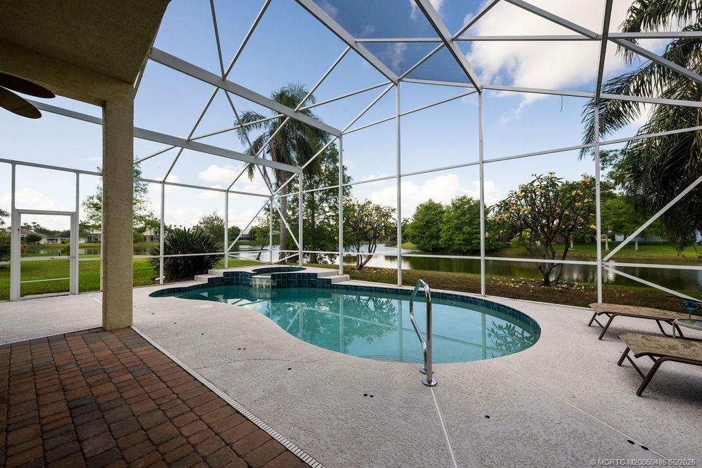 2096 Northwest Marsh Rabbit Lane Stuart, FL 34994 - Photo 28 of 58 a view of a swimming pool with a patio and a yard