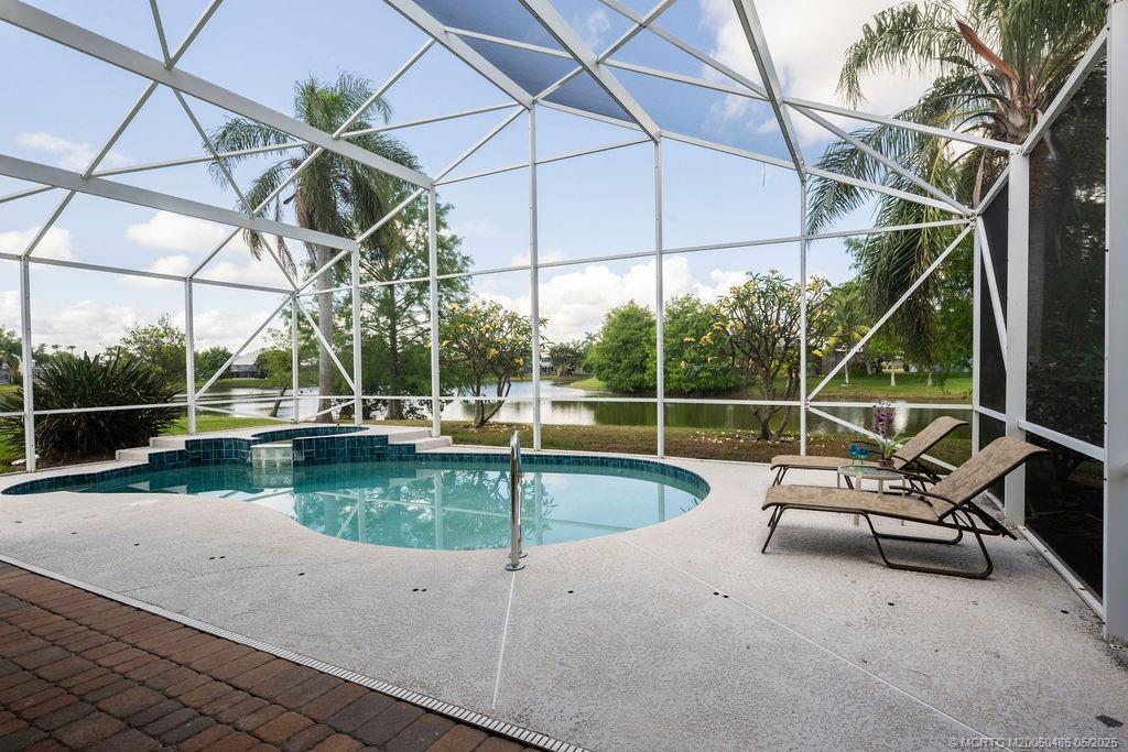 2096 Northwest Marsh Rabbit Lane Stuart, FL 34994 - Photo 29 of 58 a view of a swimming pool with a patio and a yard