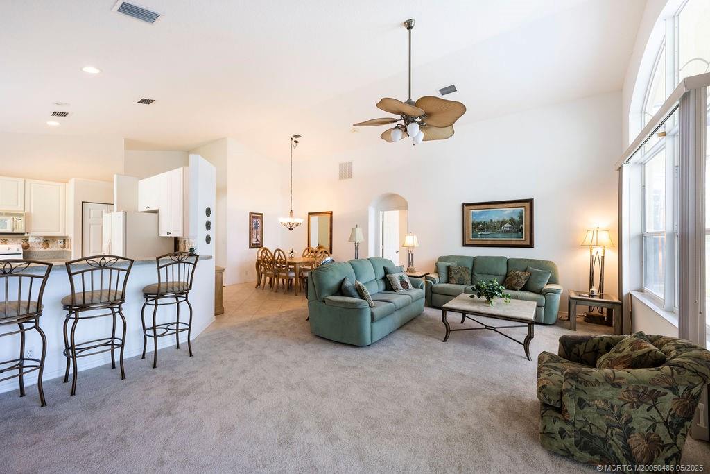 2096 Northwest Marsh Rabbit Lane Stuart, FL 34994 - Photo 30 of 58 a living room with furniture and a chandelier