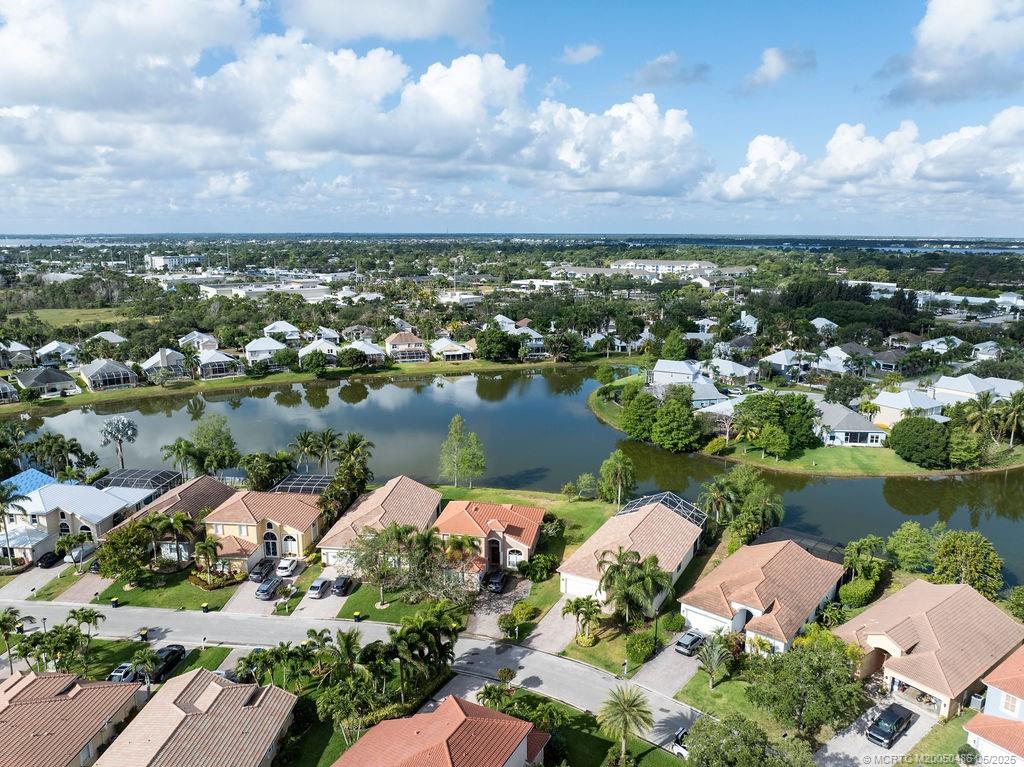2096 Northwest Marsh Rabbit Lane Stuart, FL 34994 - Photo 3 of 58 an aerial view of lake residential house with outdoor space and garden