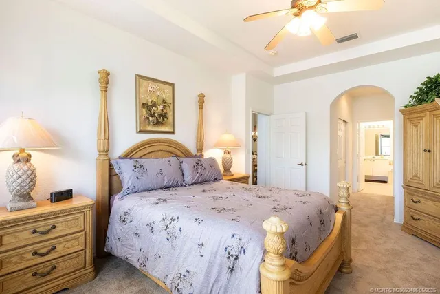 a spacious bedroom with a bed and a window