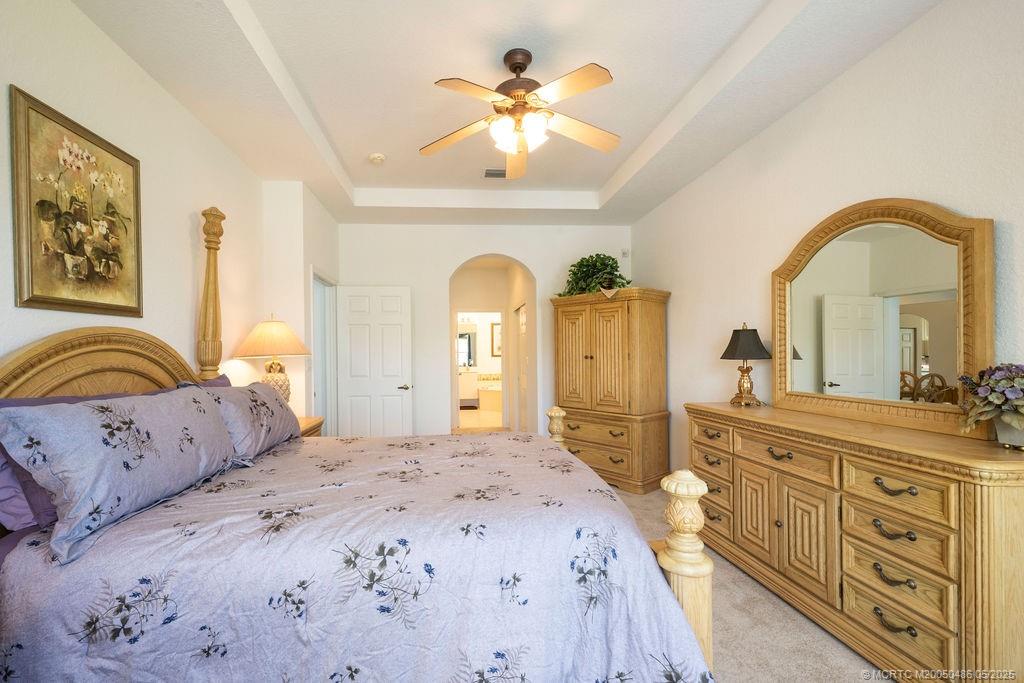 2096 Northwest Marsh Rabbit Lane Stuart, FL 34994 - Photo 44 of 58 a bedroom with a bed and a dresser