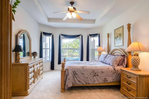 a spacious bedroom with a bed and a refrigerator