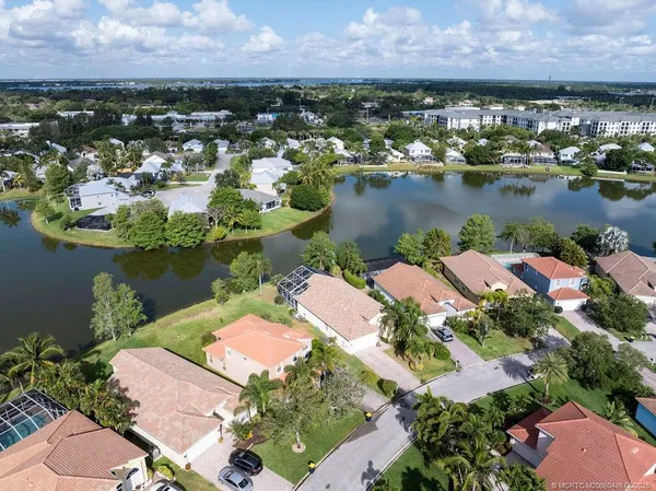 an aerial view of lake and residential houses with outdoor space