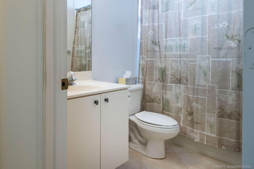 2096 Northwest Marsh Rabbit Lane Stuart, FL 34994 - Photo 51 of 58 a bathroom with a sink toilet and a mirror