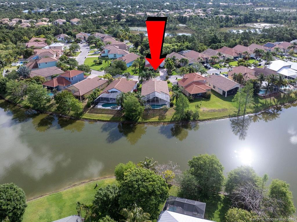 2096 Northwest Marsh Rabbit Lane Stuart, FL 34994 - Photo 6 of 58 an aerial view of residential houses with outdoor space and lake view