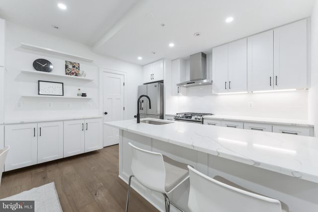 a kitchen with a sink window and cabinets