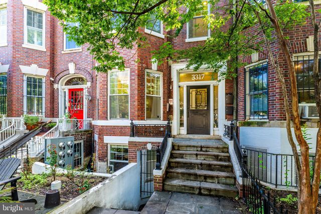 a front view of a building with outdoor seating