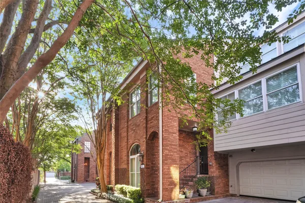 a front view of a house with a tree