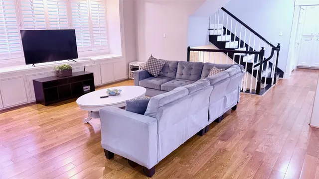 a living room with furniture or chandelier and a flat screen tv