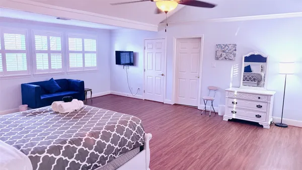 a bedroom with a bed and wooden floor