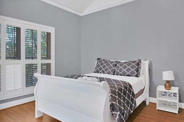 a bedroom with a bed and a window with outer view