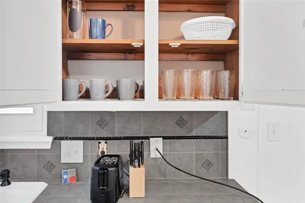 a kitchen with stainless steel appliances a table and chairs in it