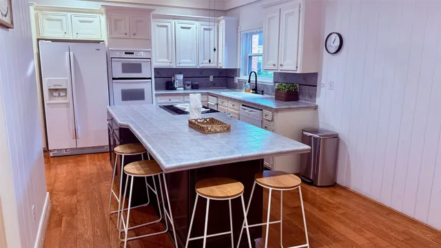a view of a dining room with furniture wooden floor and chandelier