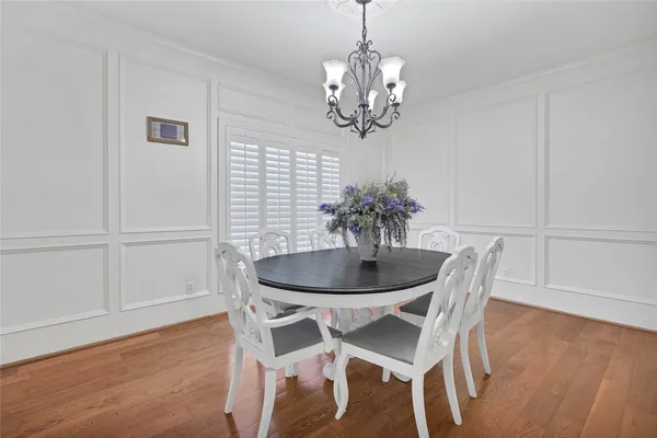 a view of a dining room with furniture wooden floor and chandelier