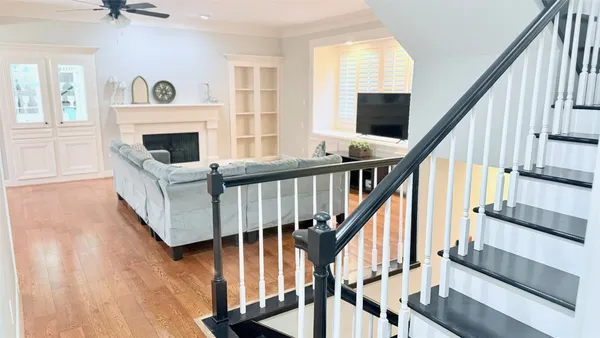 a view of an entryway with wooden floor and livingroom