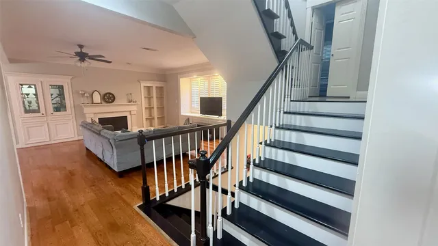 a living room with furniture a fireplace and a large window