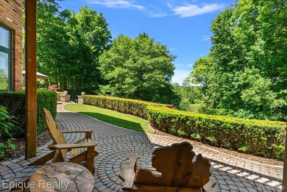 7662 Devins Ridge Clarkston, MI 48348 - Photo 11 of 81 Extensive paver patio with a circular pattern and a stone pathway