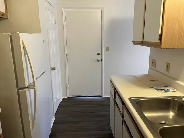 a kitchen with a stove and a refrigerator