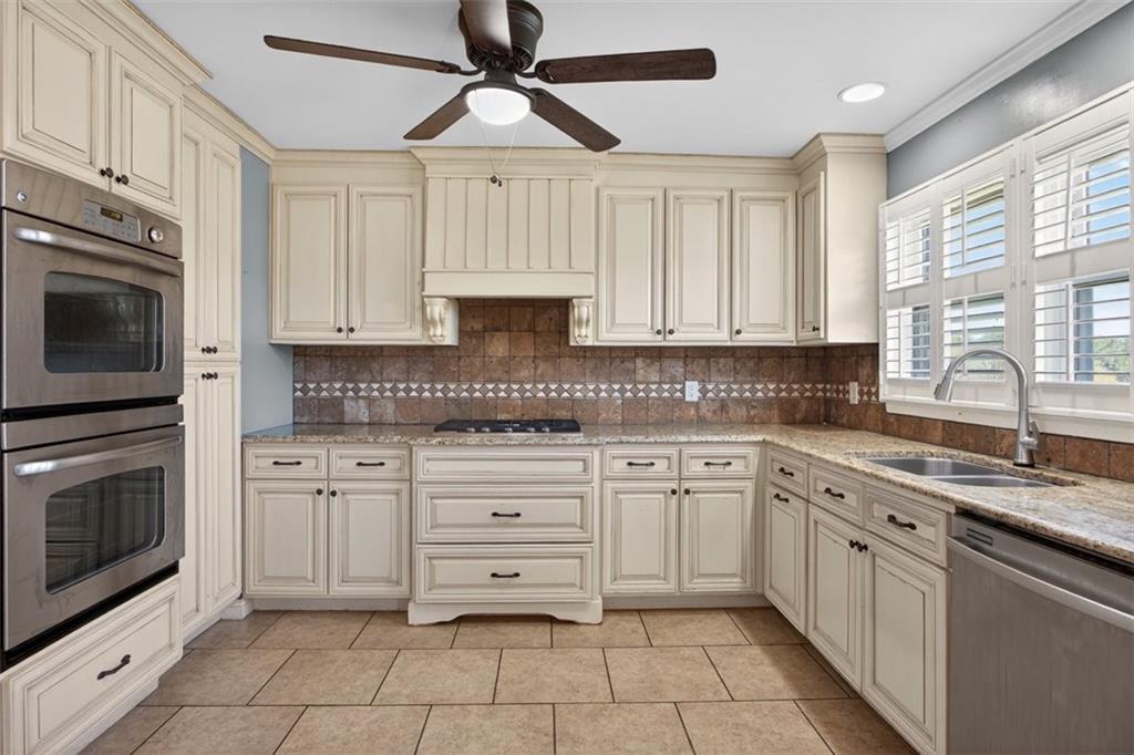 3 Berkshire Lane Rome, GA 30161 - Photo 13 of 44 a kitchen with granite countertop white cabinets stainless steel appliances and a window