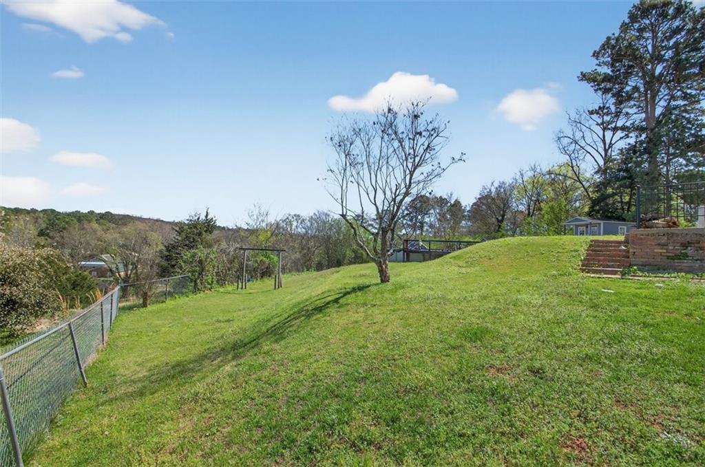 3 Berkshire Lane Rome, GA 30161 - Photo 38 of 44 a view of a grassy field with trees around