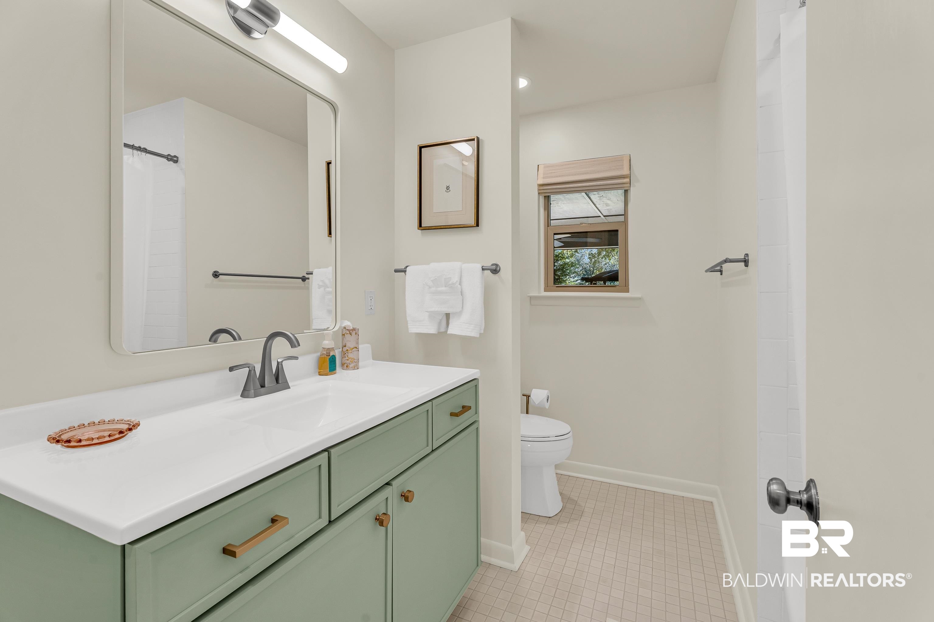 357 Azalea Street Fairhope, AL 36532 - Photo 15 of 22 Full bath featuring vanity, light tile patterned floors, and a shower with shower curtain