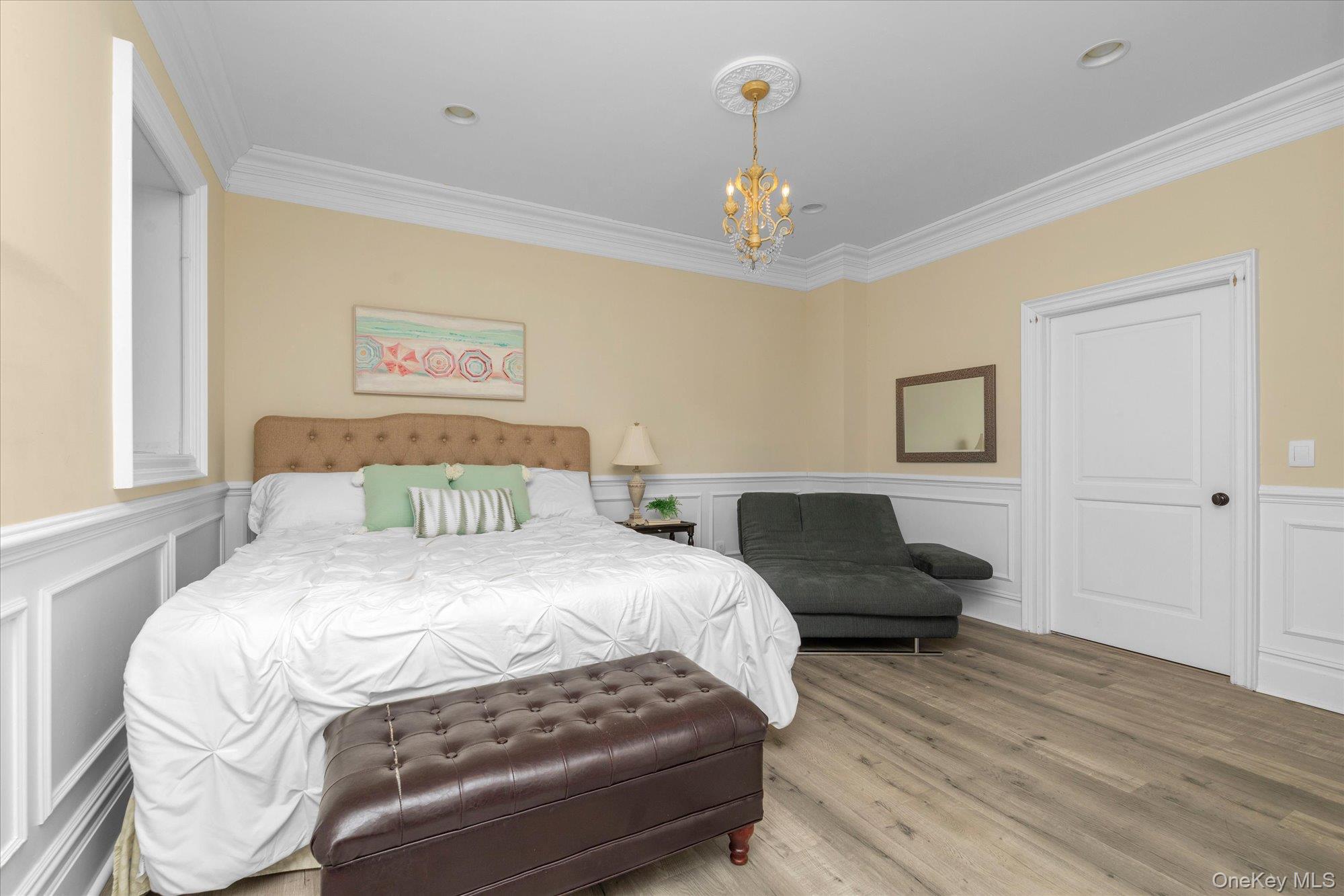 8 Norgate Road Glen Head, NY 11545 - Photo 23 of 37 a bedroom with a bed and a chandelier