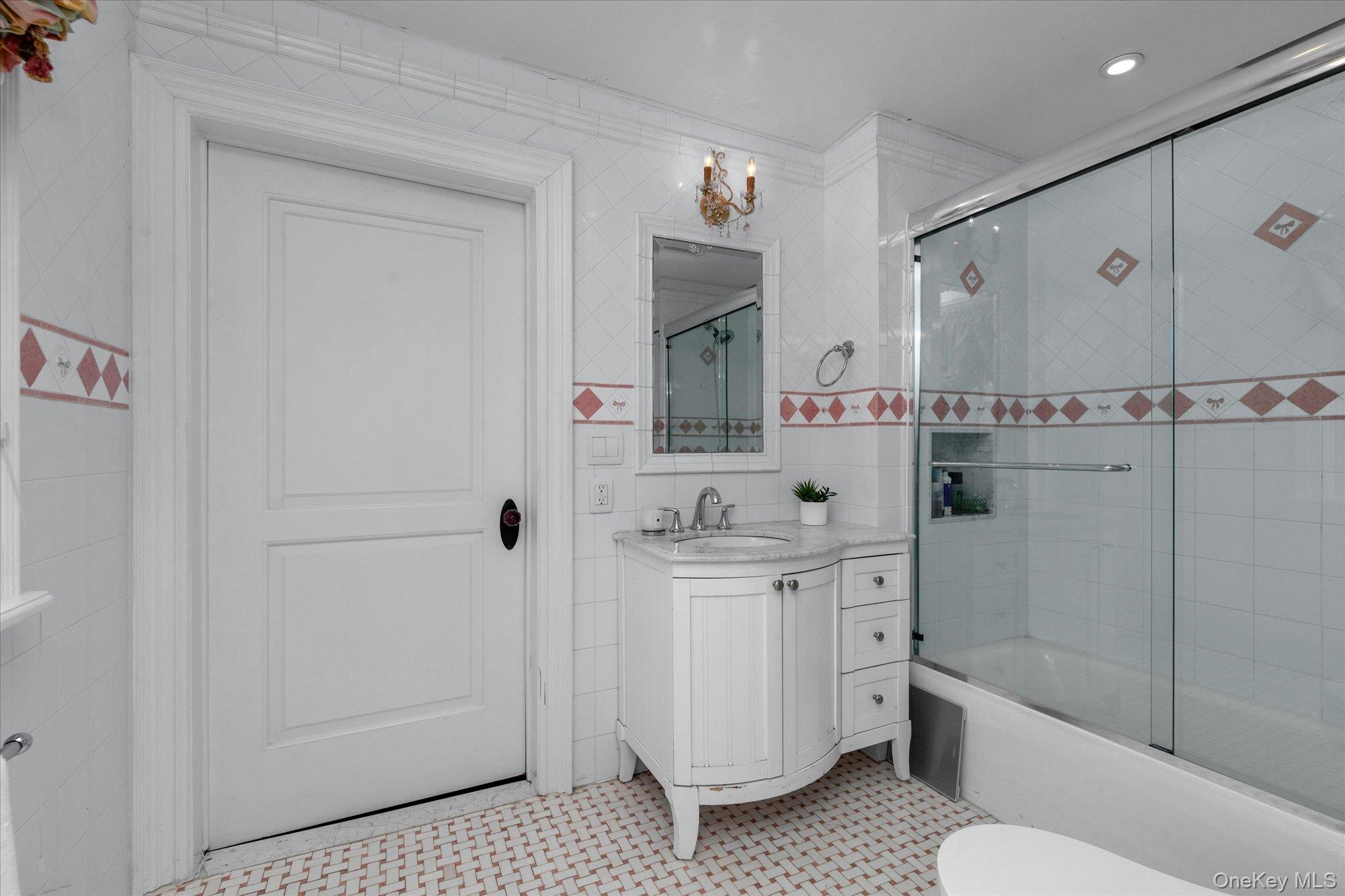 8 Norgate Road Glen Head, NY 11545 - Photo 24 of 37 a bathroom with a bathtub a sink a toilet and a mirror