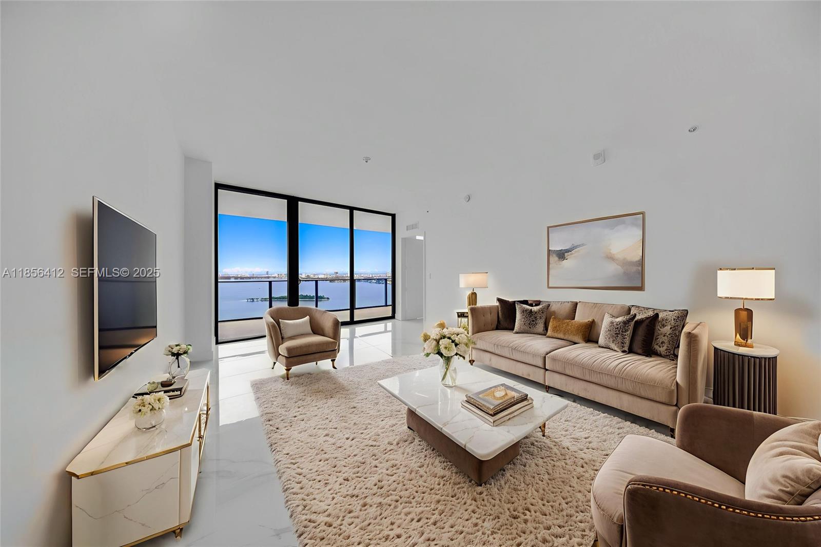 700 Northeast 24th Street, Unit 2704 Miami, FL 33137 - Photo 16 of 88 a living room with furniture and a flat screen tv