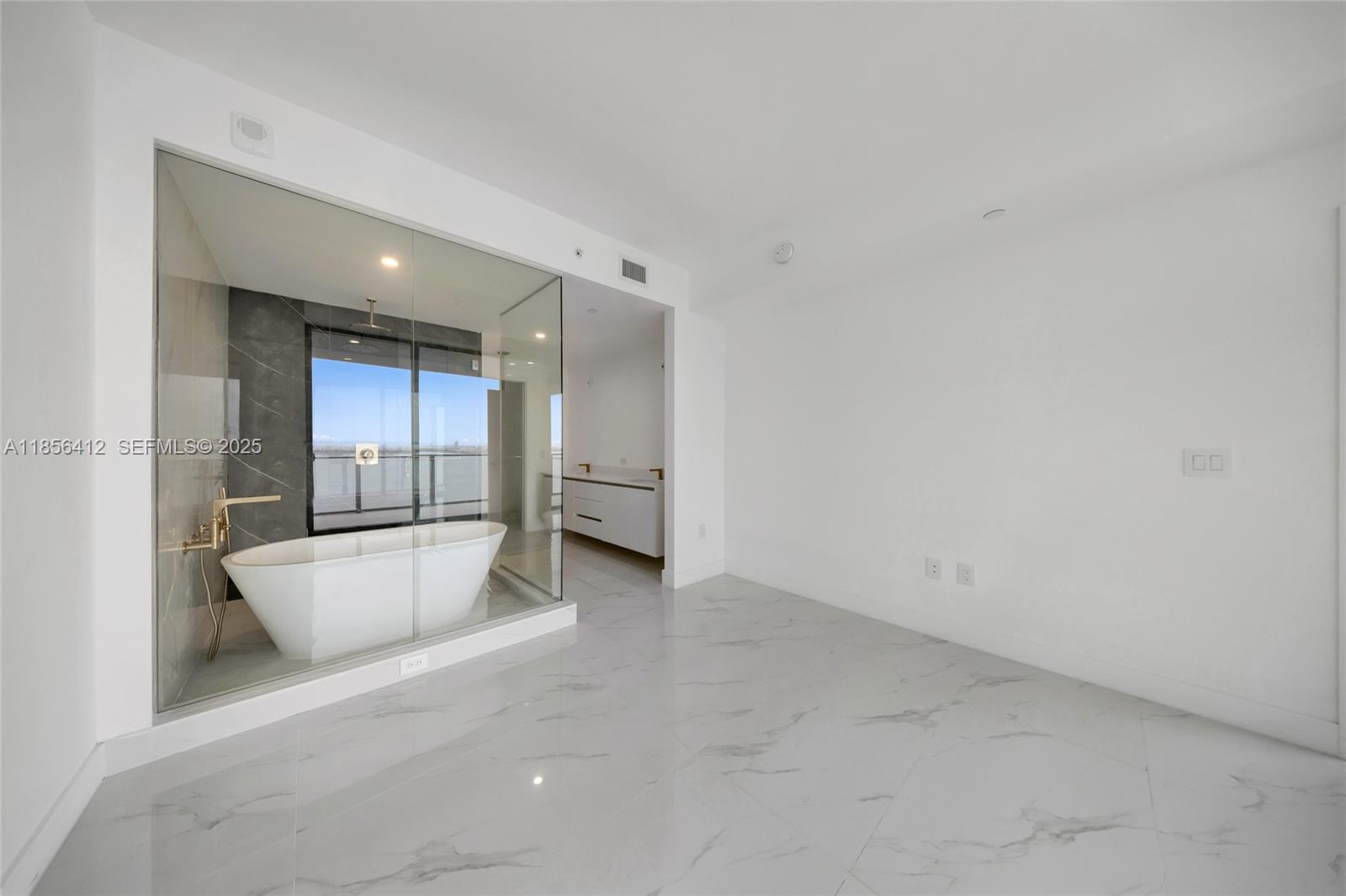 700 Northeast 24th Street, Unit 2704 Miami, FL 33137 - Photo 29 of 88 an empty room with wooden floor and windows