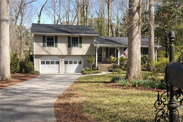 a view of a house with backyard and sitting area