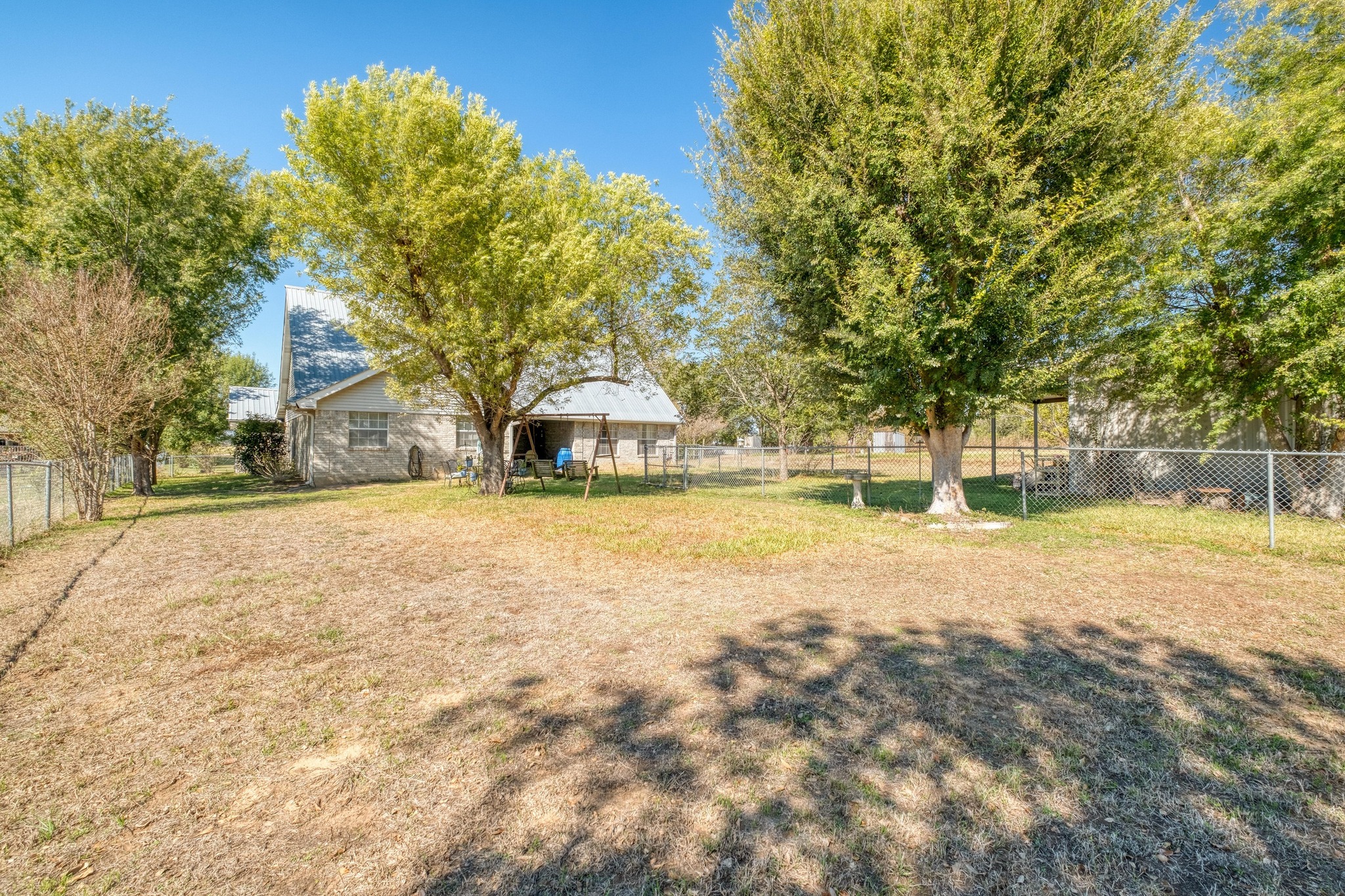 153 Pleasant Grove Road Elgin, TX 78621 - Photo 2 of 34 View of fenced backyard