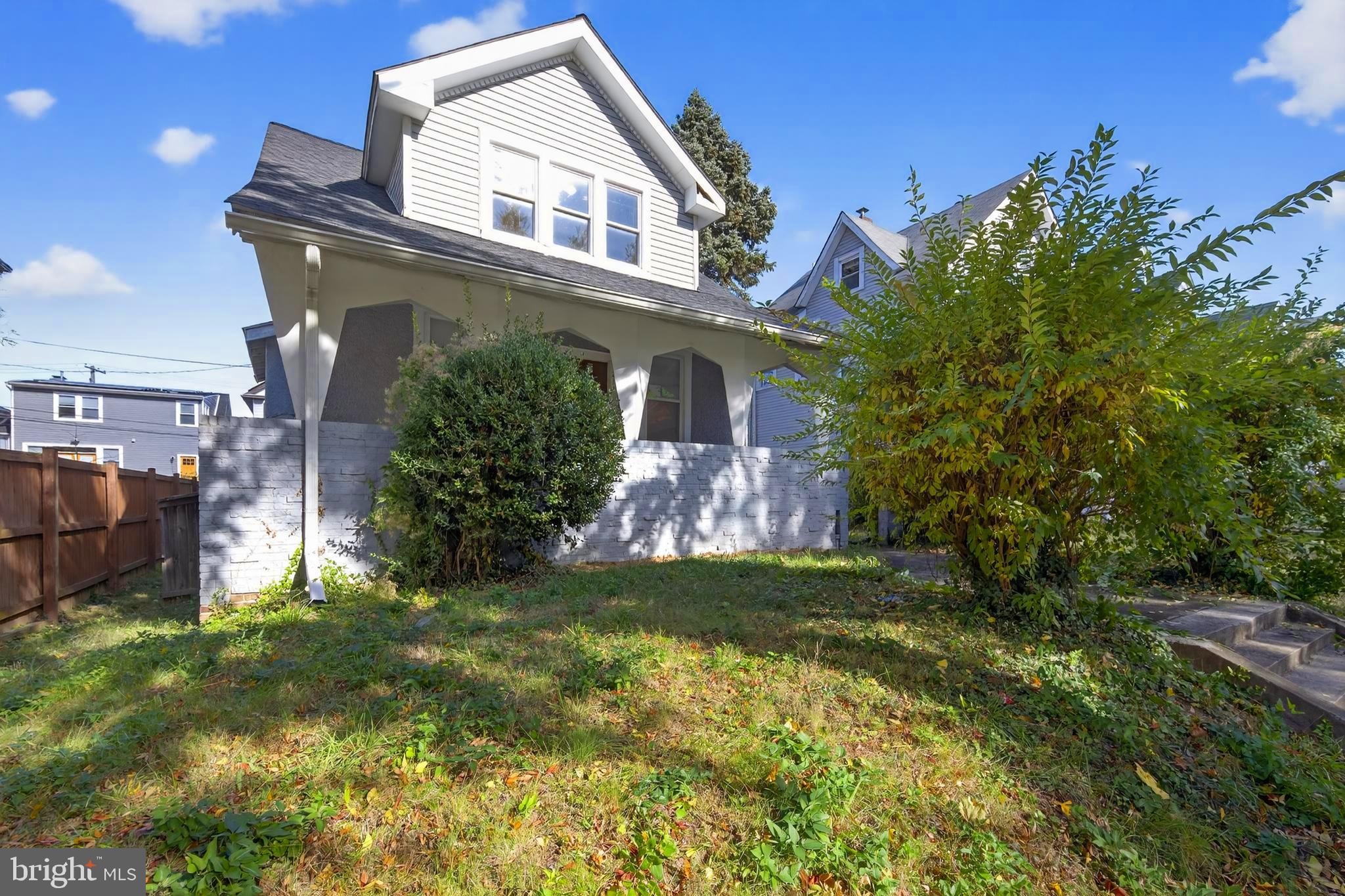 a view of a house with a small yard and a garden
