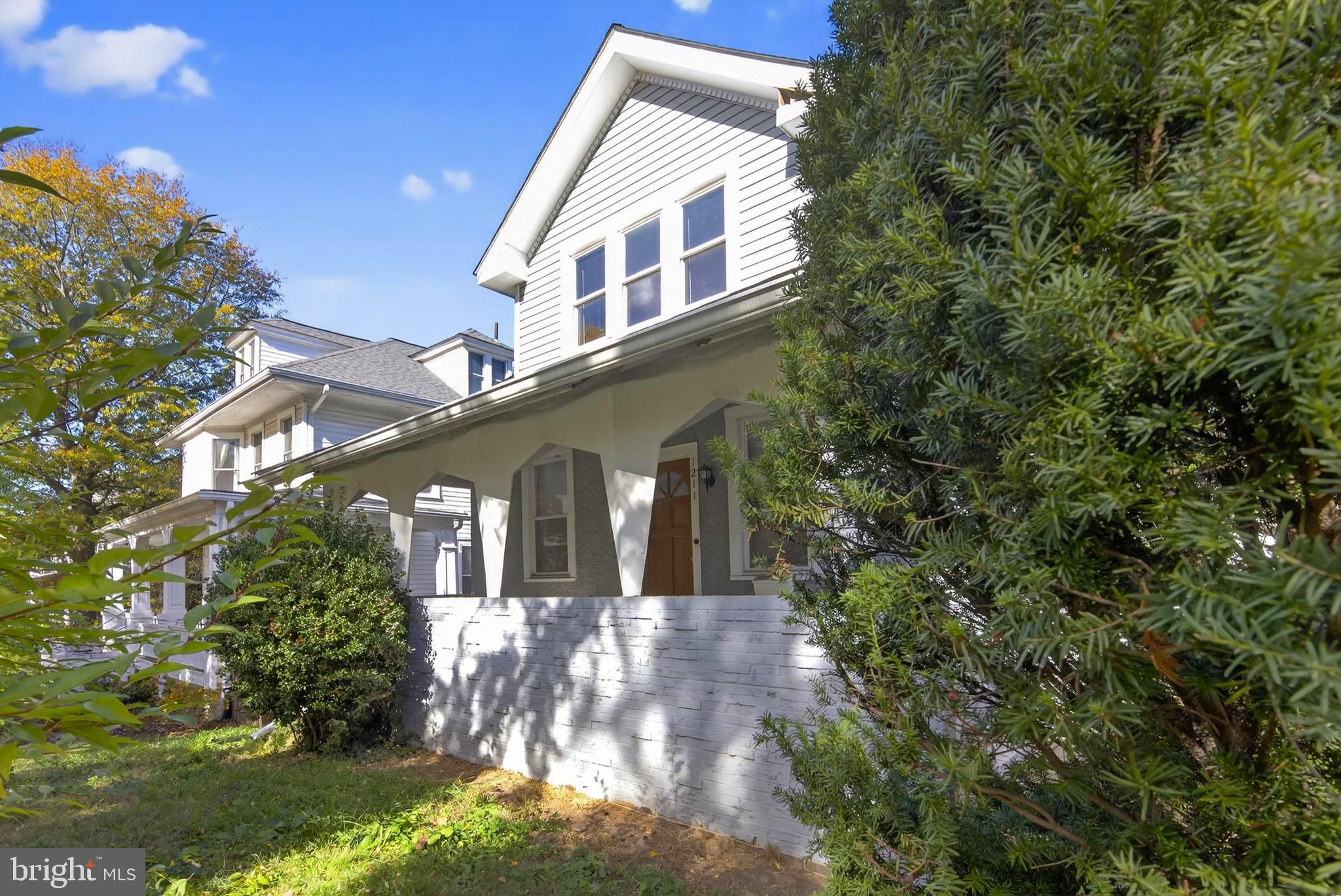 1211 Delafield Place Northwest Washington, DC 20011 - Photo 3 of 28 a front view of a house with a yard