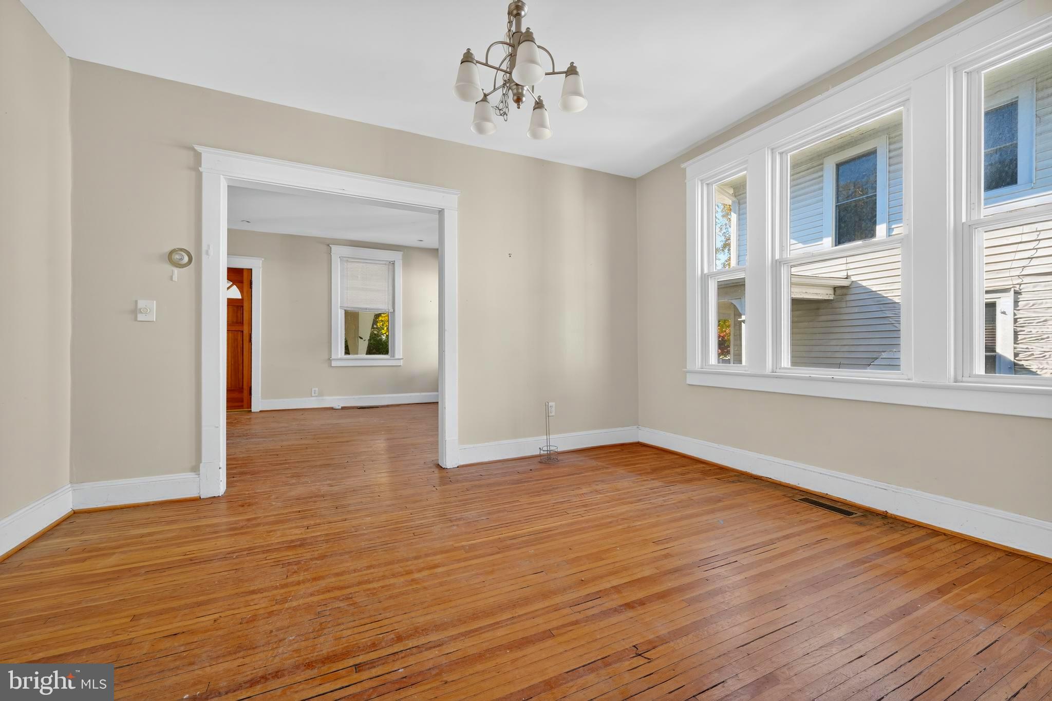1211 Delafield Place Northwest Washington, DC 20011 - Photo 10 of 28 a view of an empty room with wooden floor and a window