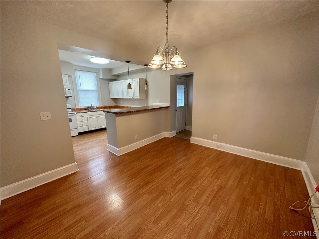 1417 Williamsburg Road Richmond, VA 23231 - Photo 11 of 35 a view of a room with wooden floor and a ceiling fan