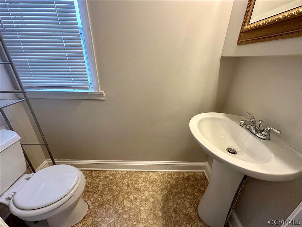 1417 Williamsburg Road Richmond, VA 23231 - Photo 13 of 35 a bathroom with a toilet a sink and a mirror