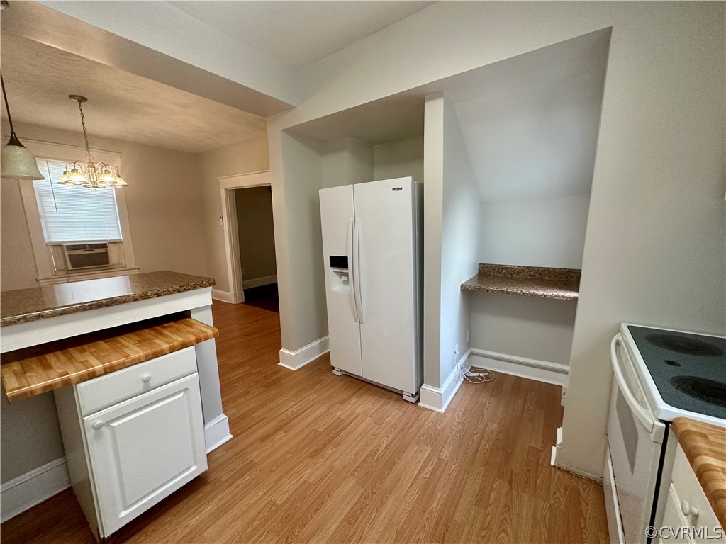 1417 Williamsburg Road Richmond, VA 23231 - Photo 8 of 35 a kitchen with white cabinets and wooden floor