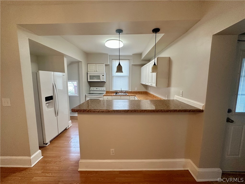 1417 Williamsburg Road Richmond, VA 23231 - Photo 9 of 35 a kitchen with stainless steel appliances granite countertop a refrigerator a sink dishwasher a stove and white countertops with wooden floor