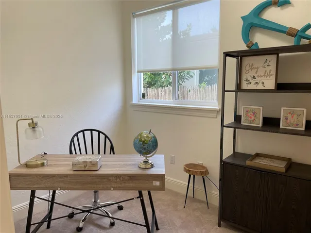 a view of a dining room with furniture and window